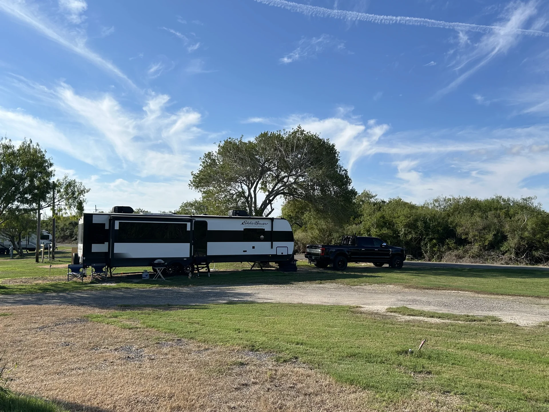 Guest RV site with open lawn and wide Texas sky at Down By The Bay RV Resort