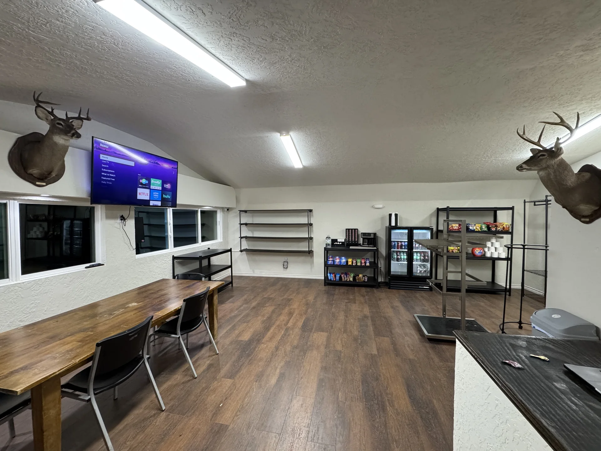Camp store and guest lounge interior with seating, beverages, snacks, and television at Down By The Bay RV Resort